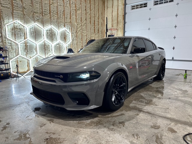 Gray Dodge Charger with dark wheels and window tint